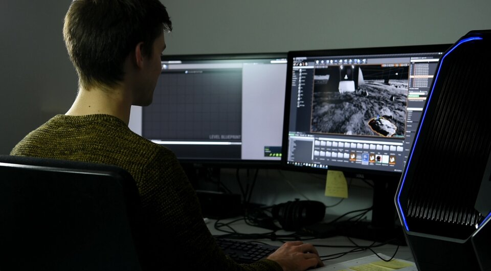 ESA trainee Sander Coene works on a virtual reality platform for robotics