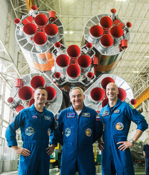 Members of Expedition 60 pose with their Soyuz launcher