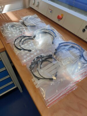 One stack of EAC 3D printed parts for face shields in bags ready for delivery