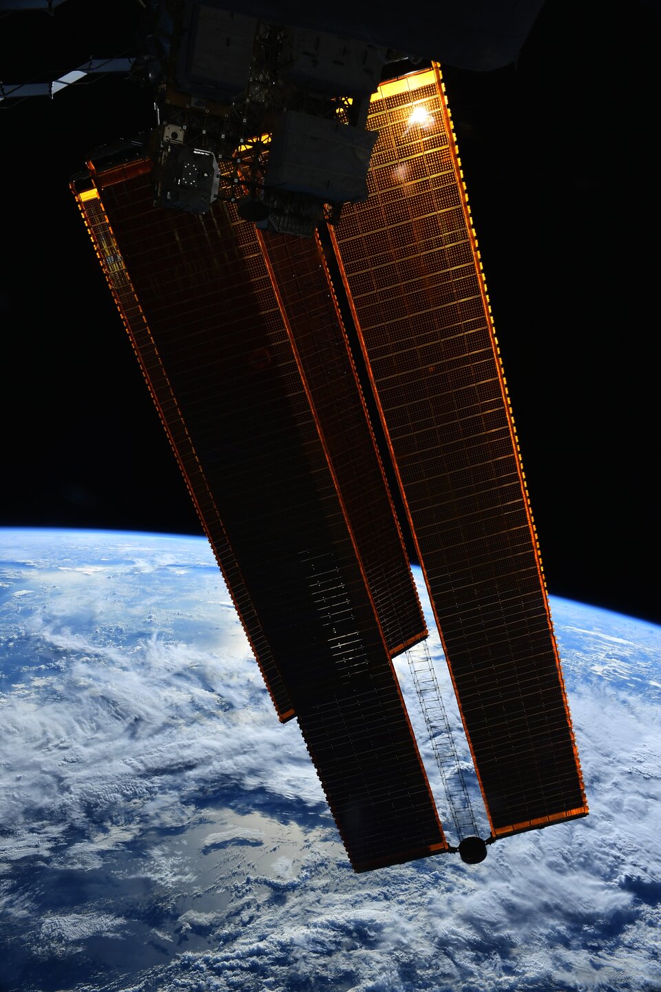 Space Station solar panels over Earth