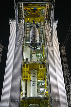 Vega's fairing hoisted to the top of the mobile gantry for integration with the launch vehicle