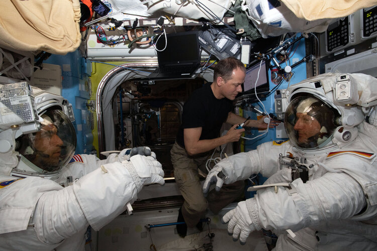 NASA astronaut Raja Chari and ESA astronaut Matthias Maurer check their EVA suits